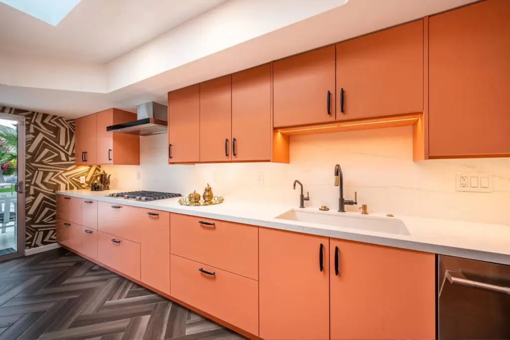 Pink painted paint-ready kitchen cabinets
