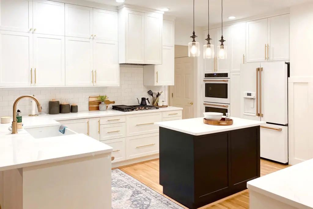 White Shaker wall cabinets and Black Shaker island in a kitchen remodel